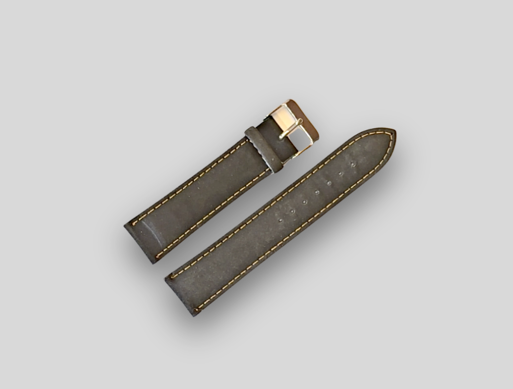 Gray leather watch strap with gold stitching on a light gray background