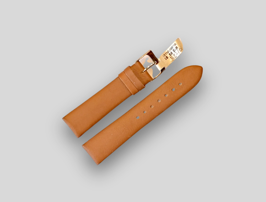 Brown leather watch strap with gold buckle on a light gray background
