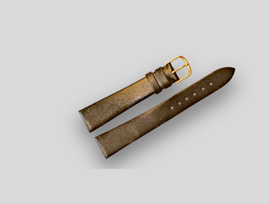 Brown leather watch strap with gold buckle on a light gray background