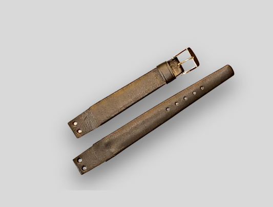 Brown leather watch strap on a light gray background