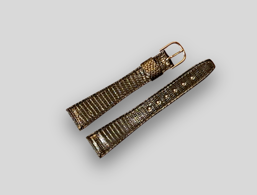 Gold watch strap on a light gray background