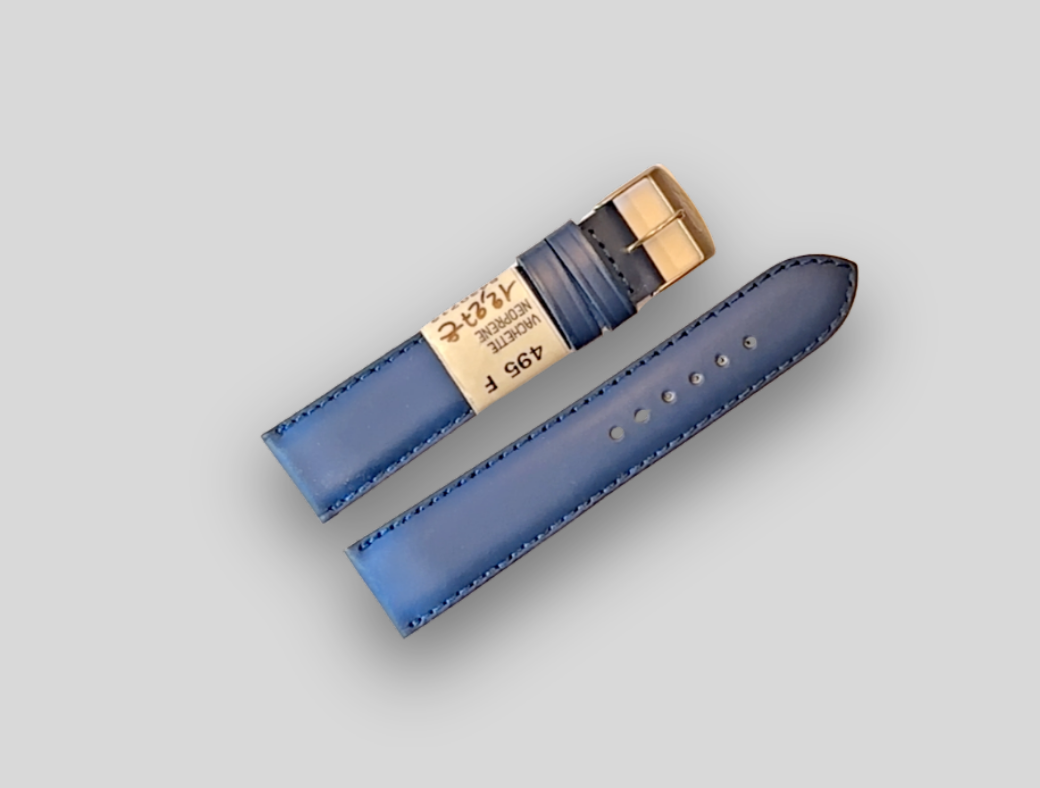 ZRC Blue watch strap with gold buckle on a light gray background
