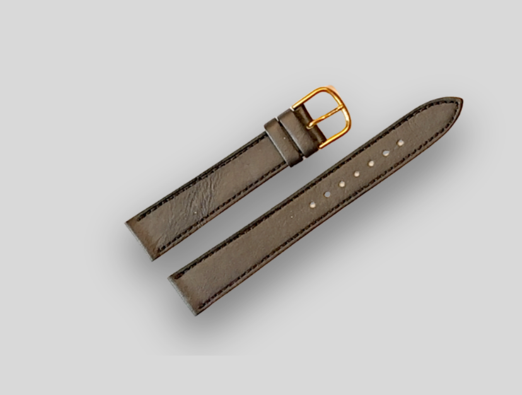 Brown leather watch strap with gold buckle on a light gray background
