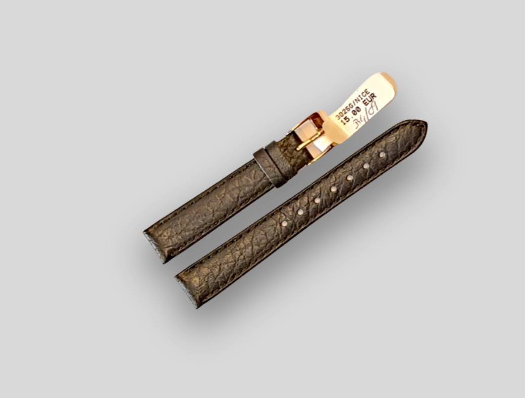 Brown watch strap with gold clasp on a light gray background